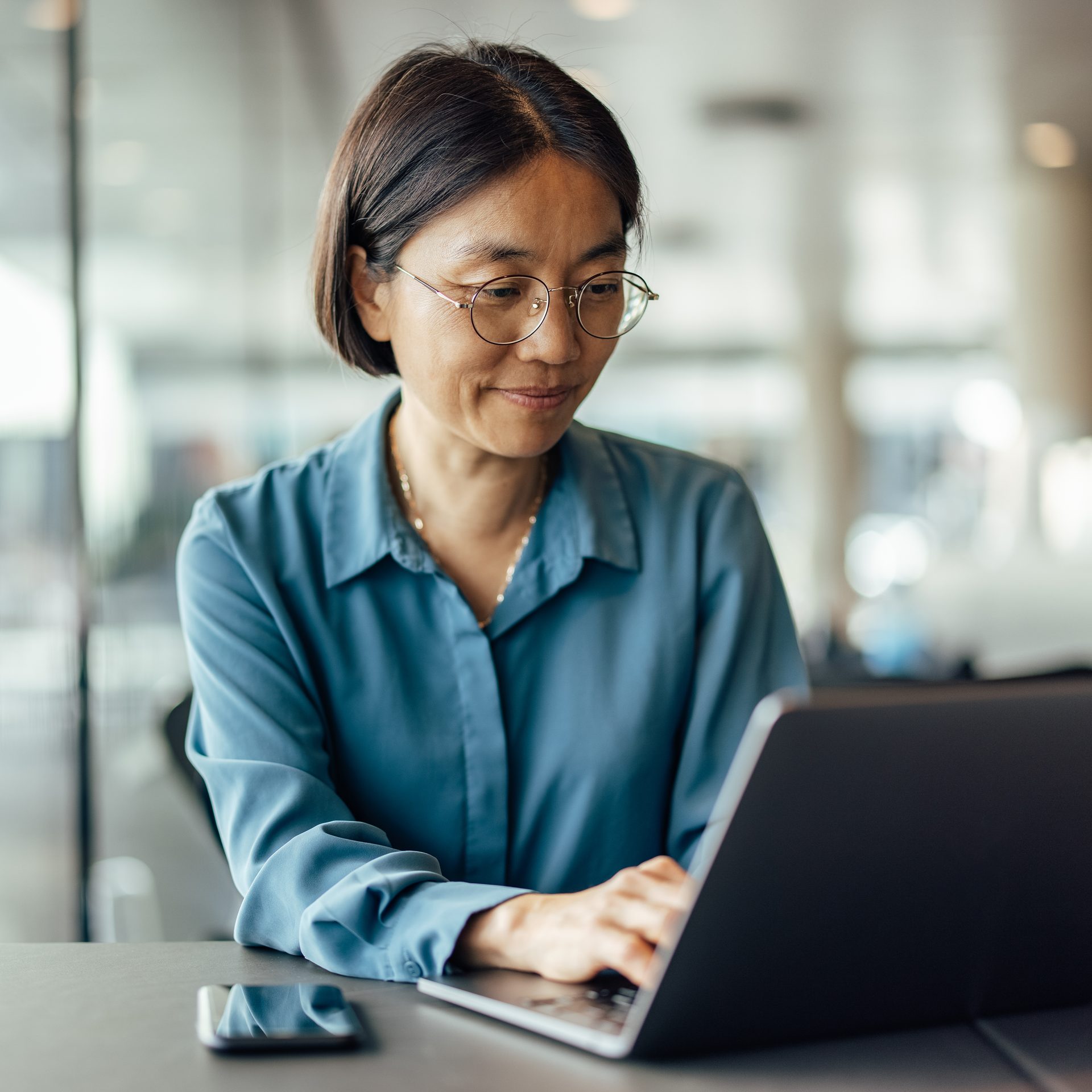 Female Google Ads professional creating a text ad on a computer