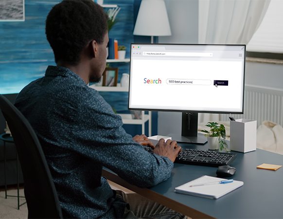 Man searches "SEO best practices" on his desktop computer